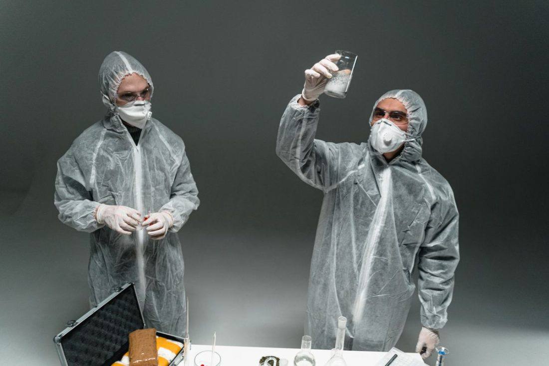 Licensed asbestos removal worker in the UK wearing protective coveralls and a respirator